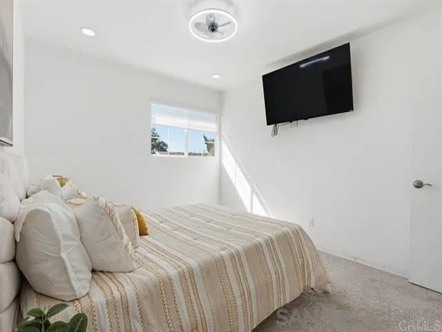 9462 Doheny Road Santee, CA 92071 - Photo 18 of 33 a bedroom with a bed and a flat screen tv