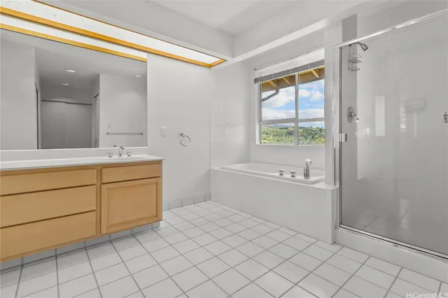 a bathroom with a sink mirror and a bathtub