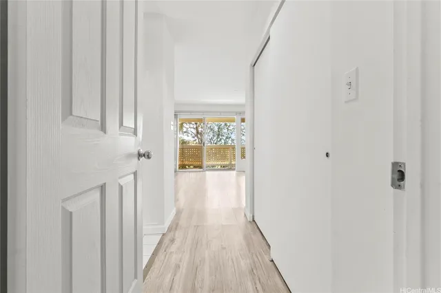 a view of a hallway with wooden floor