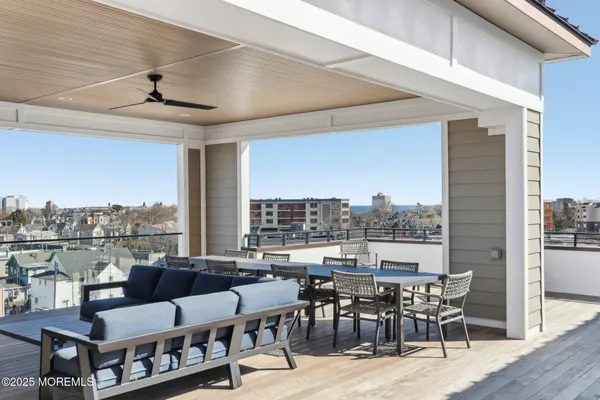 a kitchen with stainless steel appliances granite countertop a table chairs and a refrigerator