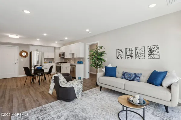 a living room with furniture and a potted plant