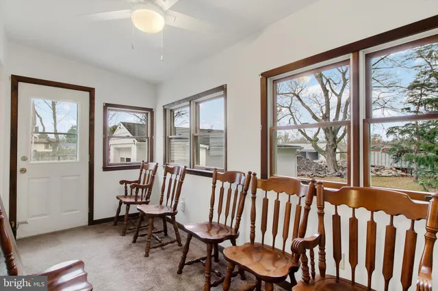 a view of a room with furniture large windows and wooden floor