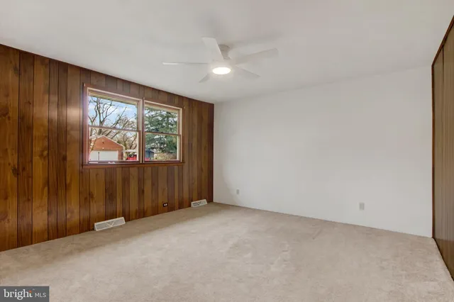 an empty room with windows cabinet and door