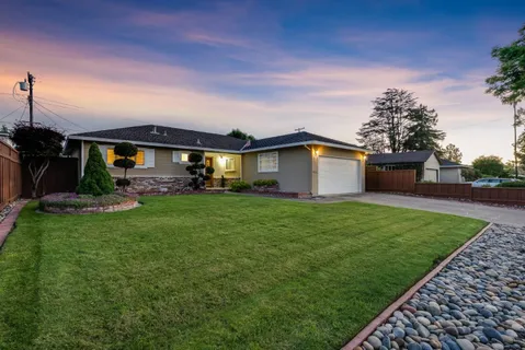 a front view of a house with garden