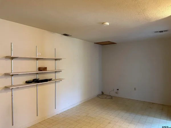 a kitchen with a refrigerator and cabinets
