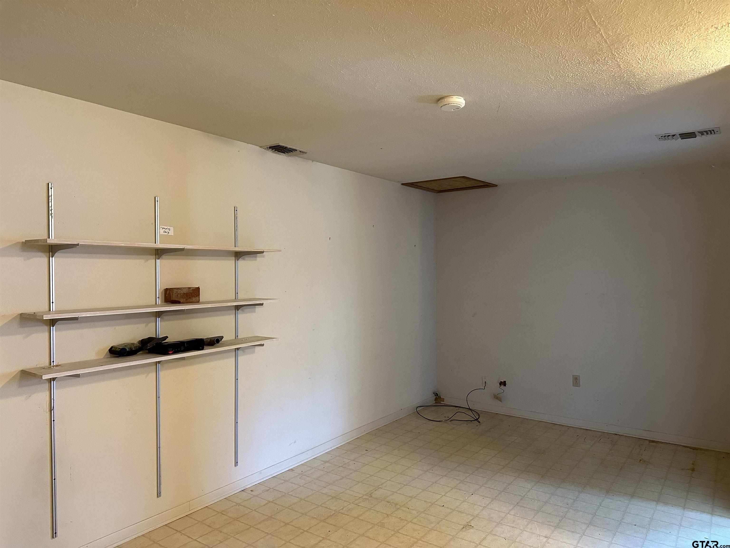 957 Farm To Market 23 Rusk, TX 75785 - Photo 14 of 25 a kitchen with a refrigerator and cabinets