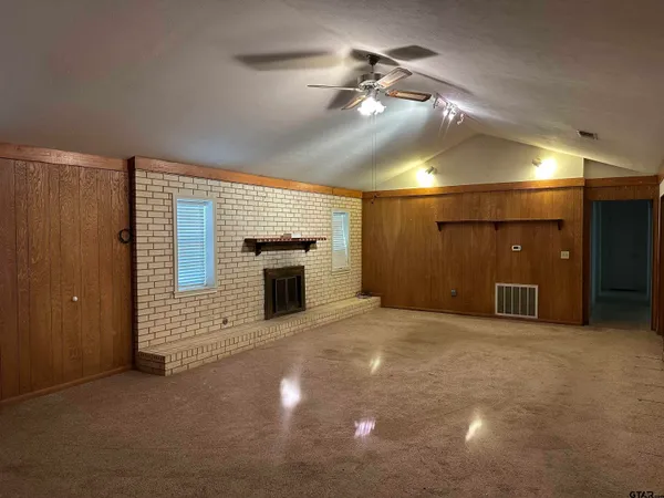 a view of an empty room with a fireplace
