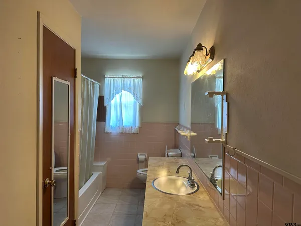 an empty room with a ceiling fan and a window