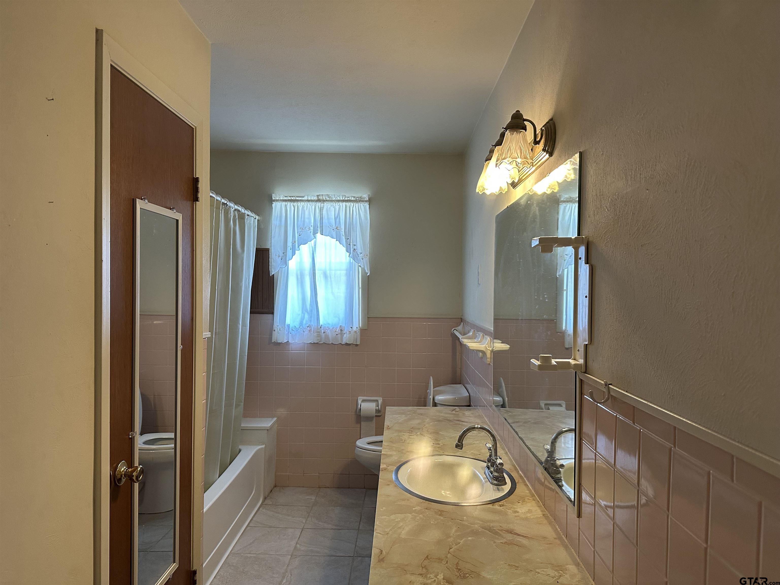 957 Farm To Market 23 Rusk, TX 75785 - Photo 17 of 25 a bathroom with a granite countertop sink and a mirror