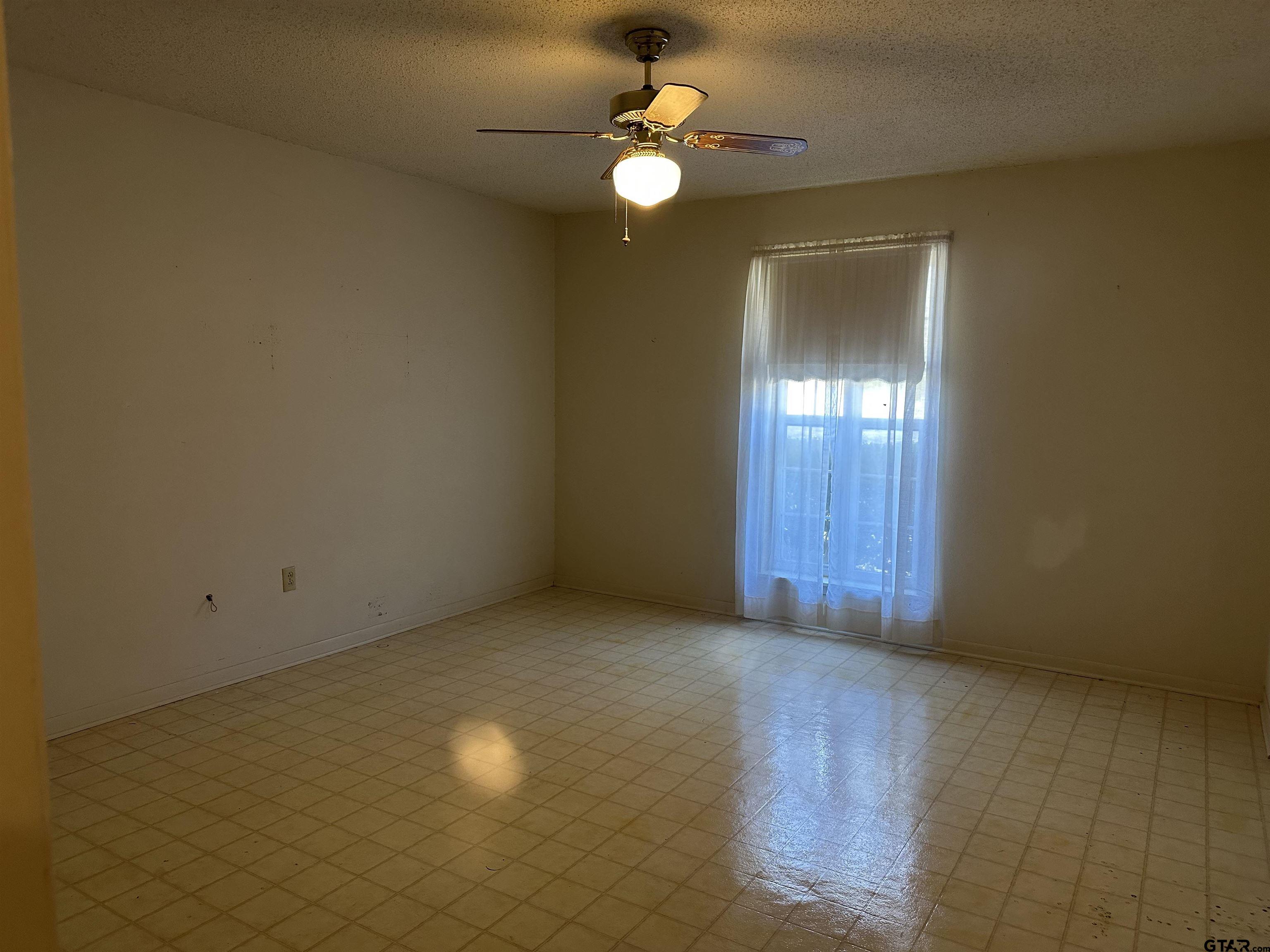 957 Farm To Market 23 Rusk, TX 75785 - Photo 19 of 25 an empty room with chandelier fan