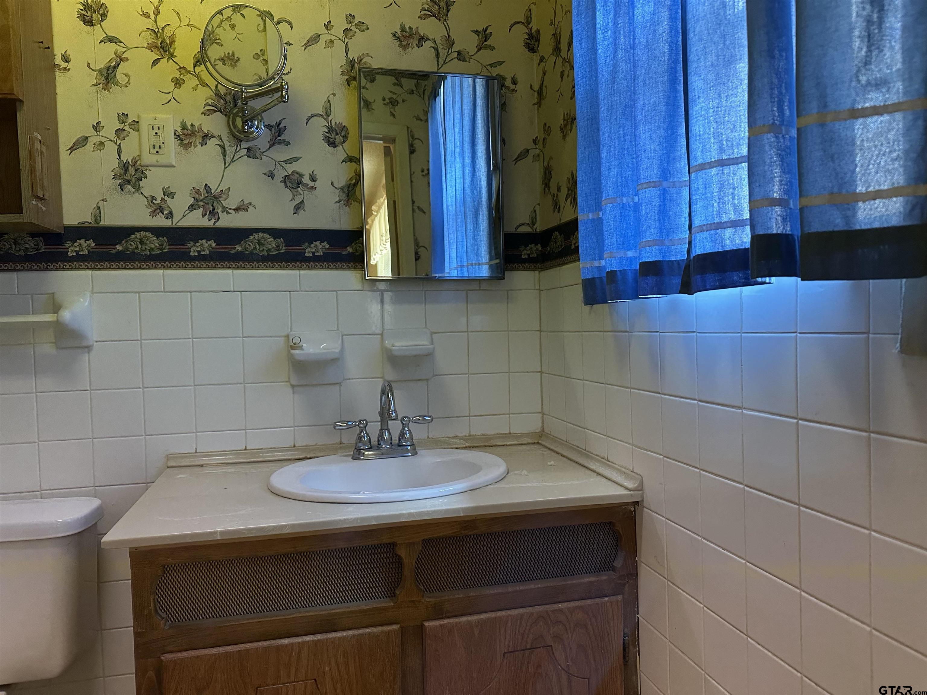 957 Farm To Market 23 Rusk, TX 75785 - Photo 22 of 25 a bathroom with a sink and a mirror