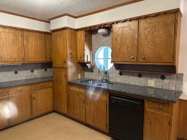 a kitchen with stainless steel appliances granite countertop a sink a stove and a microwave