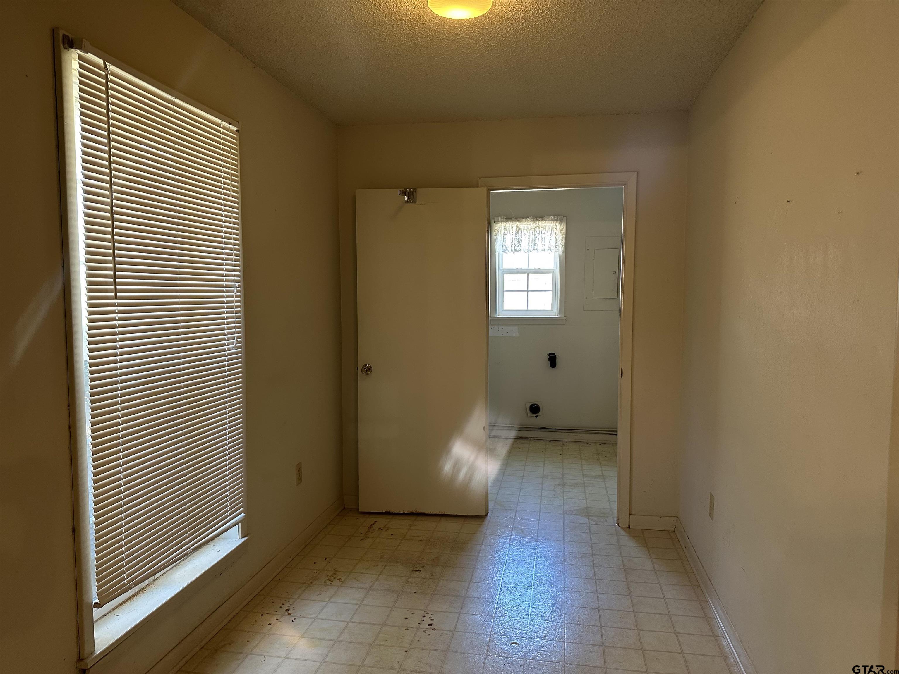 957 Farm To Market 23 Rusk, TX 75785 - Photo 10 of 25 a view of an empty room with wooden floor and a window