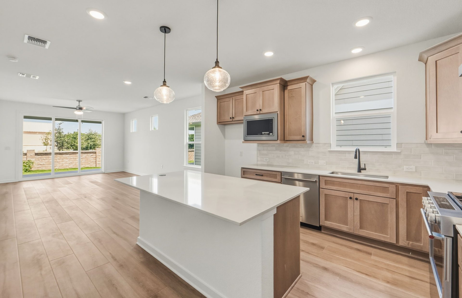 207 Smokestack Lane Georgetown, TX 78633 - Photo 4 of 21 a large kitchen with stainless steel appliances a large center island attached withe living room