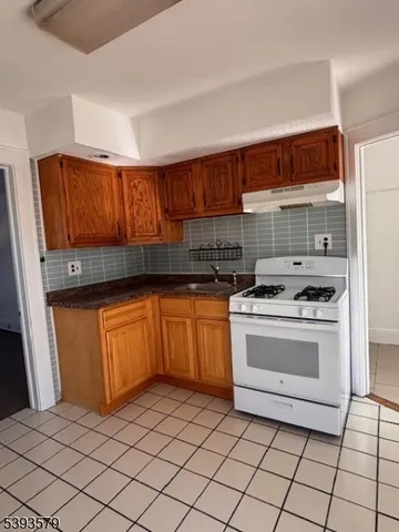 a kitchen with granite countertop cabinets and steel stainless steel appliances