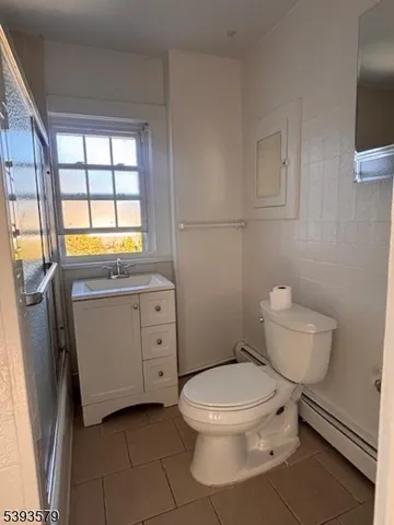 a white toilet sitting next to a bathroom sink