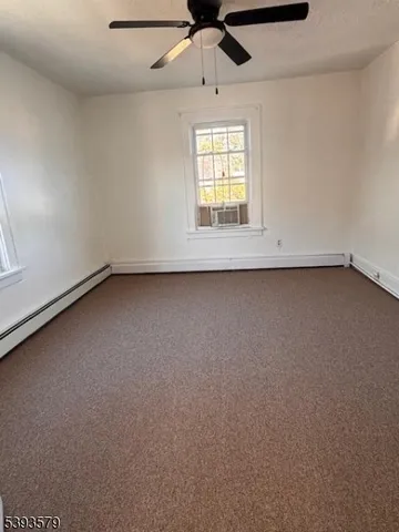 an empty room with a empty space and windows