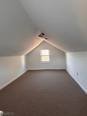 a view of an empty room and a window