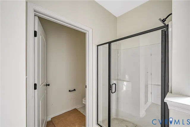 a bathroom with a granite countertop tub shower and sink