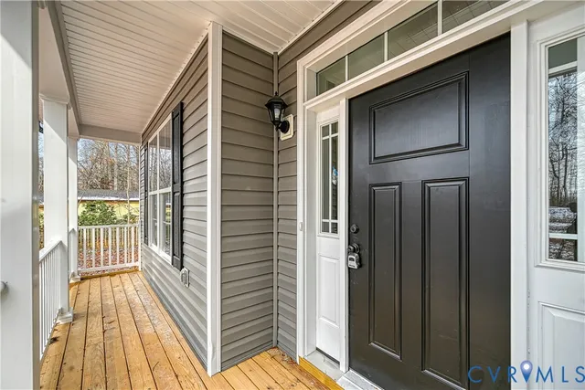 a view of a balcony with wooden floor and fence