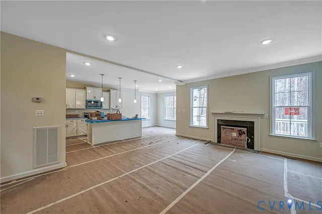 a large living room with a fireplace and a window