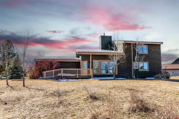 a view of a house with a snow in the yard