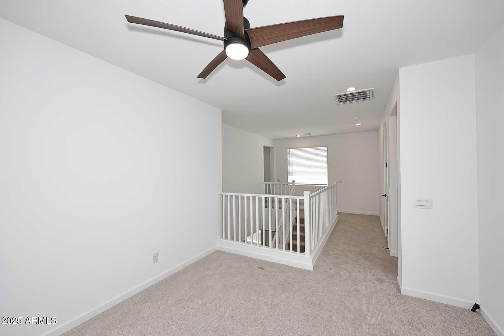 2442 West Rowel Road Phoenix, AZ 85085 - Photo 20 of 55 a view of a hallway with a ceiling fan