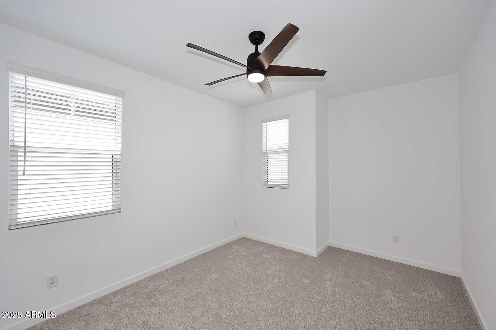 2442 West Rowel Road Phoenix, AZ 85085 - Photo 28 of 55 an empty room with windows and fan