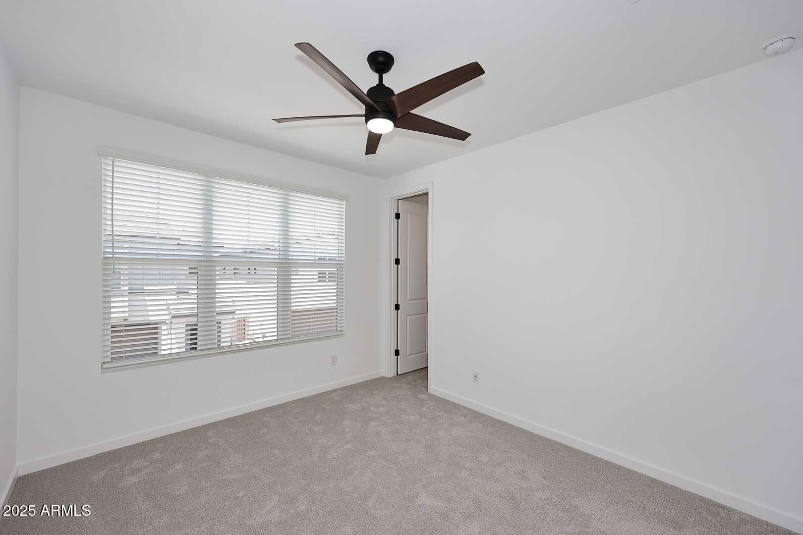 2442 West Rowel Road Phoenix, AZ 85085 - Photo 32 of 55 a view of a livingroom with a ceiling fan and window