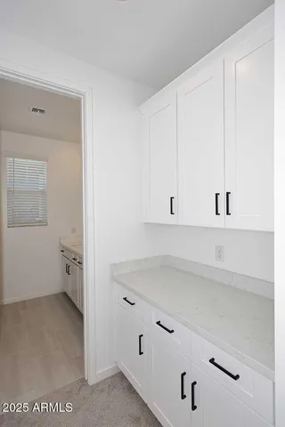 a view of a storage & utility room with a fan
