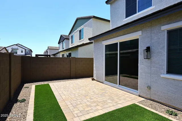 a front view of a house with garden and sitting area