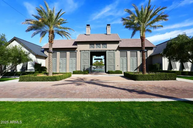 a view of a patio with table and chairs potted plants and palm trees