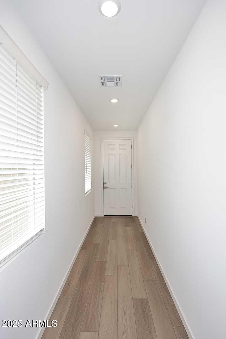 2442 West Rowel Road Phoenix, AZ 85085 - Photo 4 of 55 a view of an empty room with wooden floor and a window