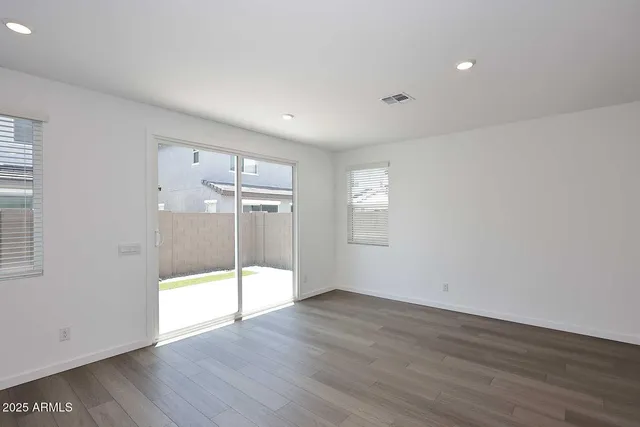 an empty room with wooden floor and door