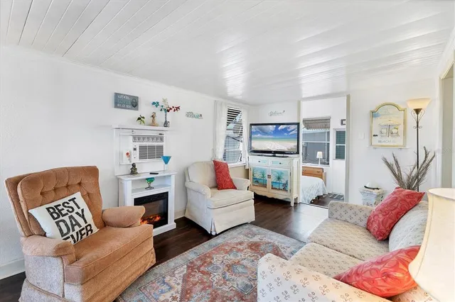 a living room with furniture and white bed