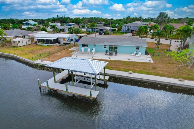 an aerial view of a house with a swimming pool yard and outdoor seating