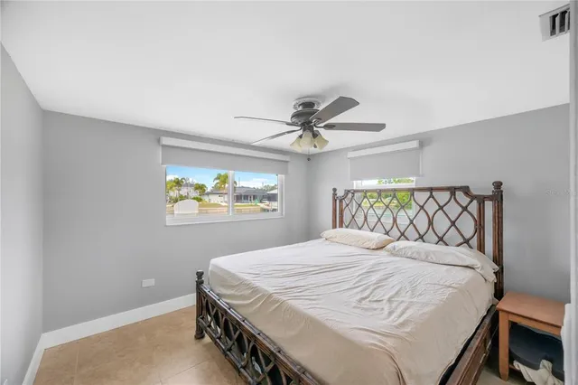 a bathroom with a granite countertop sink a toilet and a mirror