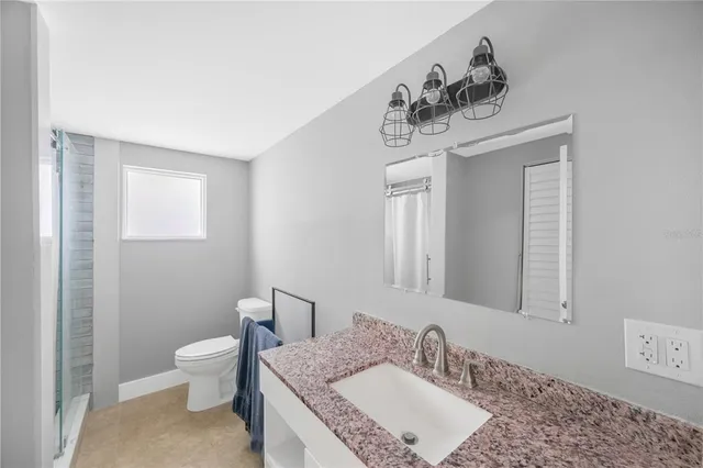 a bathroom with a toilet and a shower curtain