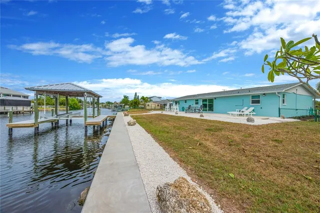 a view of swimming pool with outdoor seating and lake view