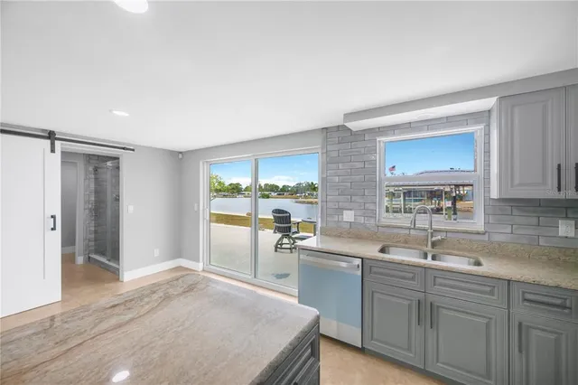 a view of kitchen with furniture and refrigerator