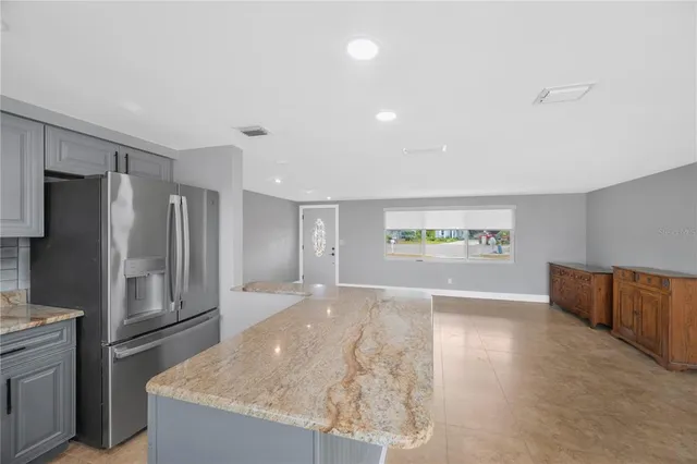 a view of kitchen with cabinets microwave and stove