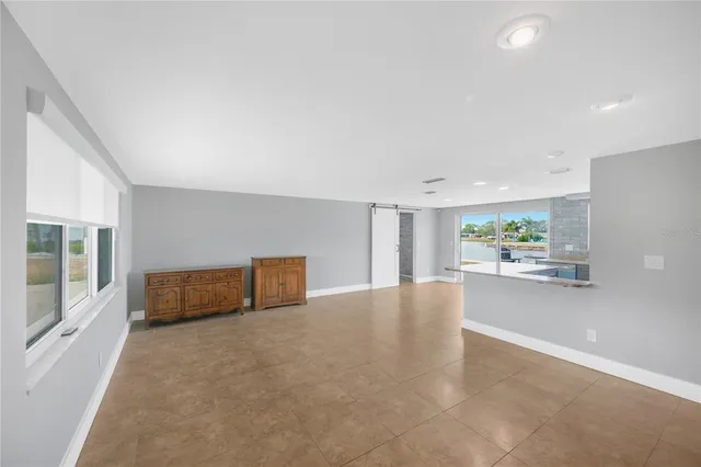 an empty room with wall painting and window