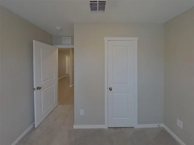 a view of hallway with closet area