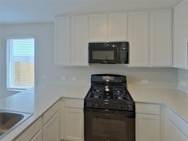 a kitchen with a stove and a microwave