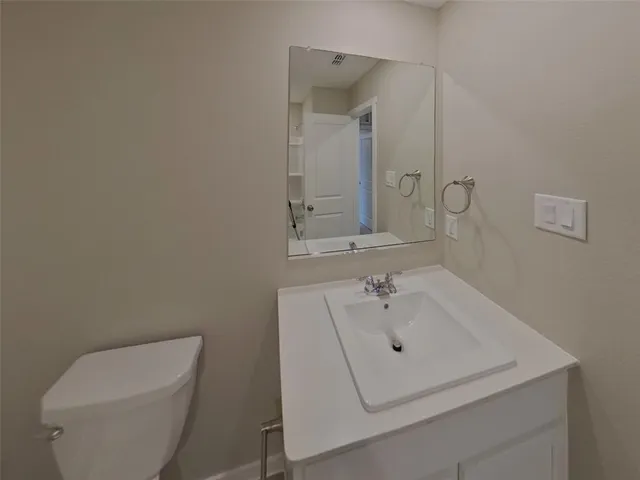 a bathroom with a sink a toilet and mirror