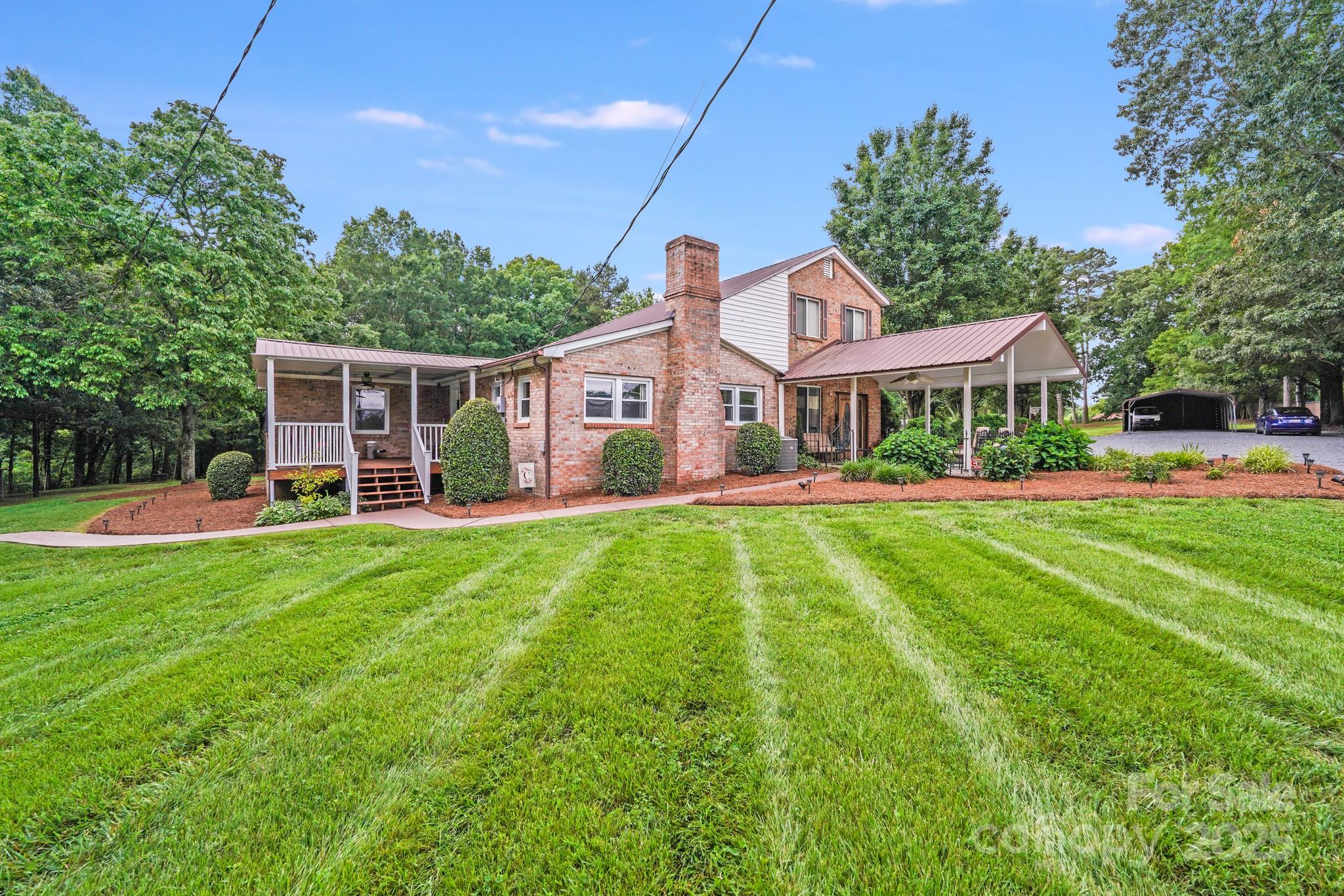 a front view of a house with a yard table and chairs