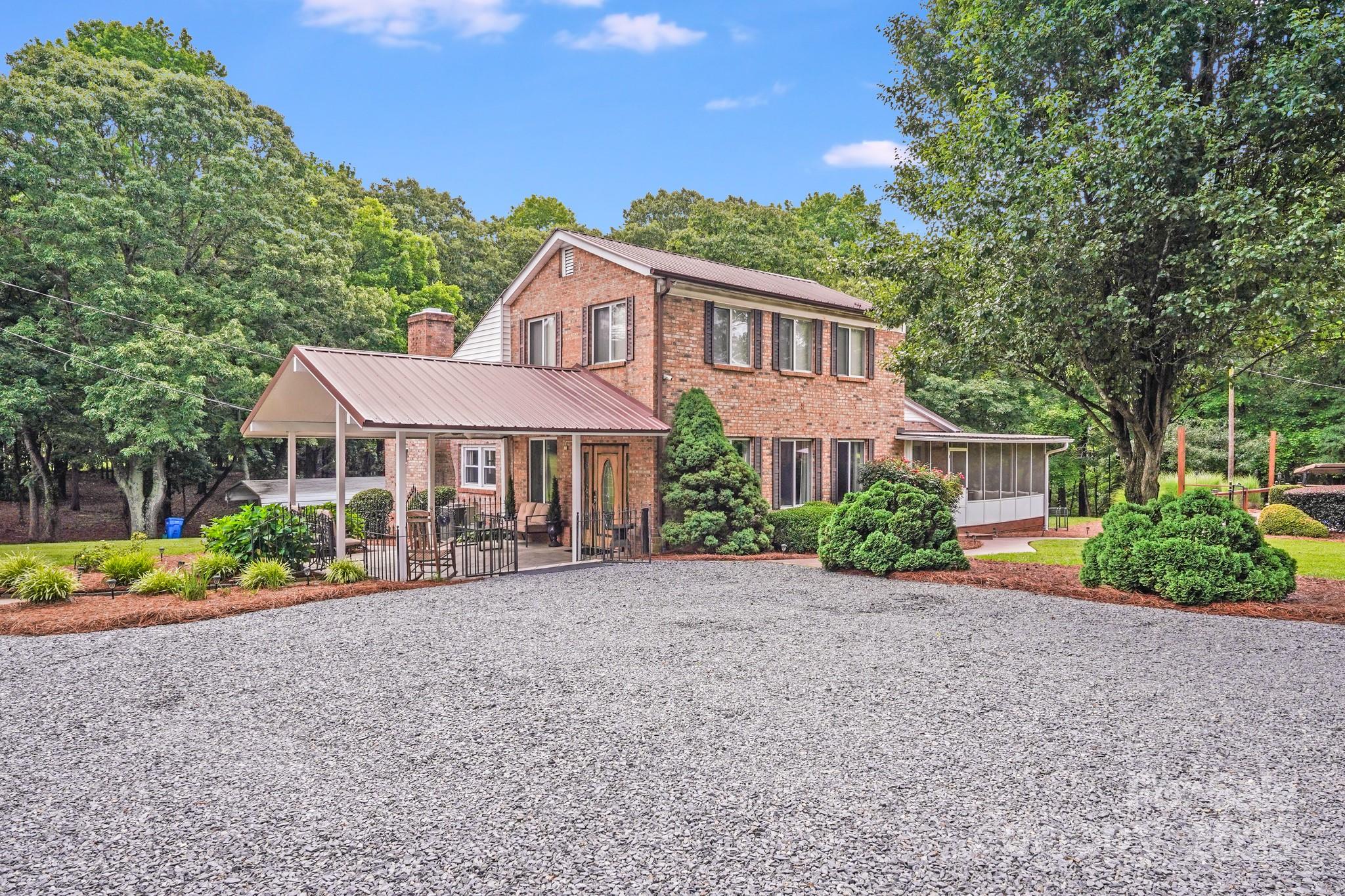 211 Drive Inn Road Locust, NC 28097 - Photo 2 of 48 a front view of a house with a garden