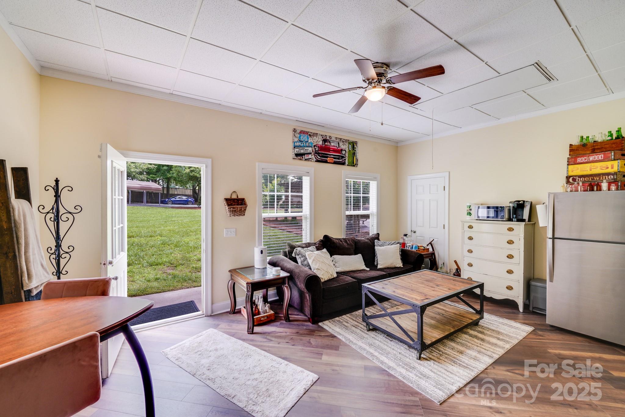 211 Drive Inn Road Locust, NC 28097 - Photo 21 of 48 a living room with furniture a window and a bookshelf