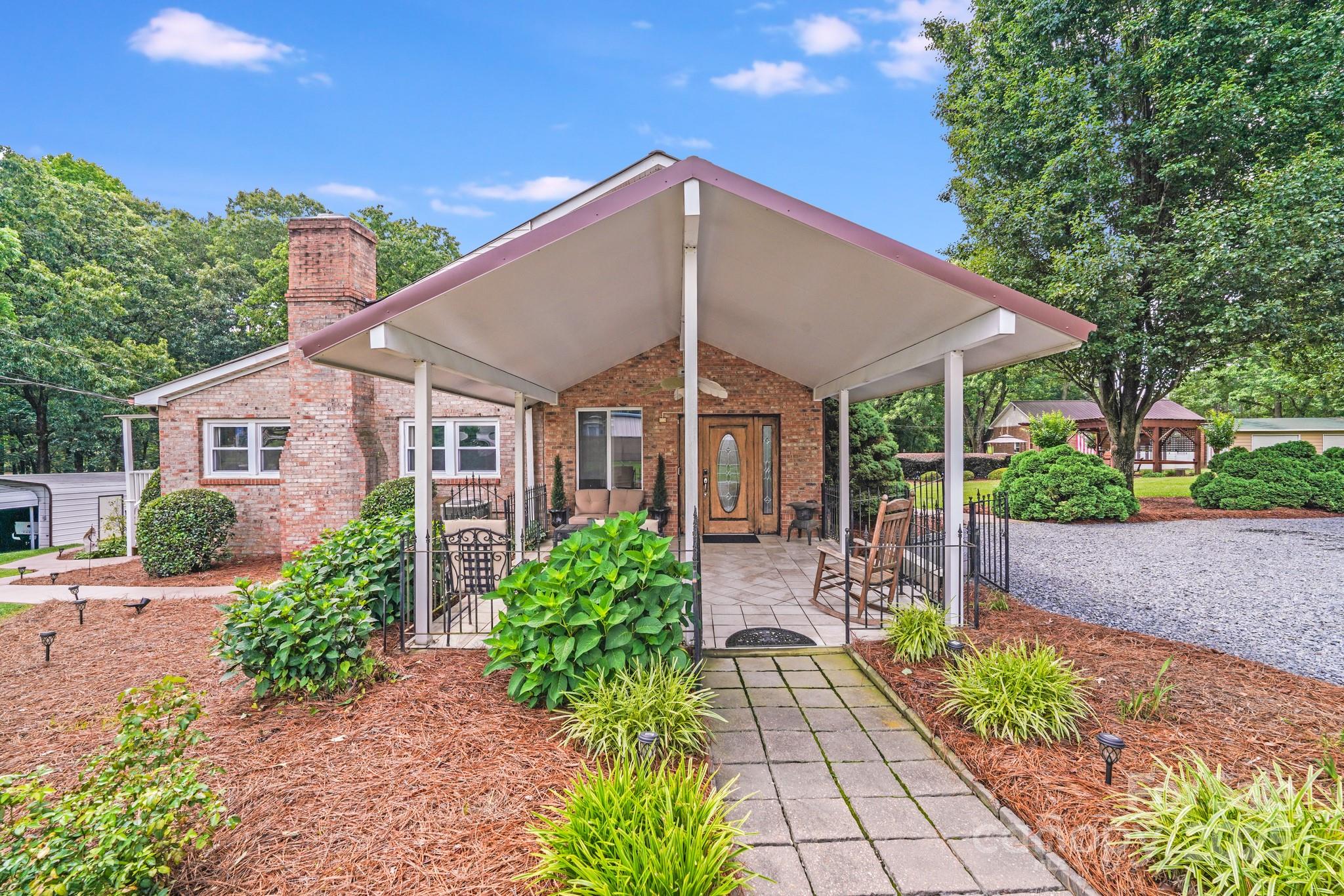 211 Drive Inn Road Locust, NC 28097 - Photo 3 of 48 a front view of a house with a yard
