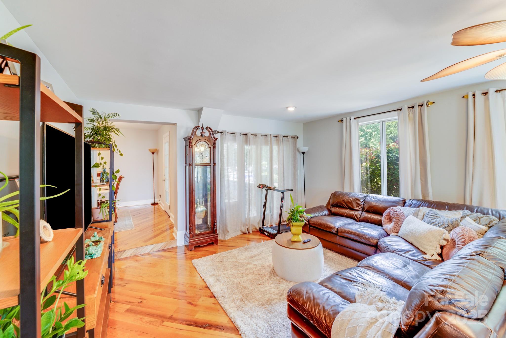211 Drive Inn Road Locust, NC 28097 - Photo 32 of 48 a living room with furniture and a flat screen tv